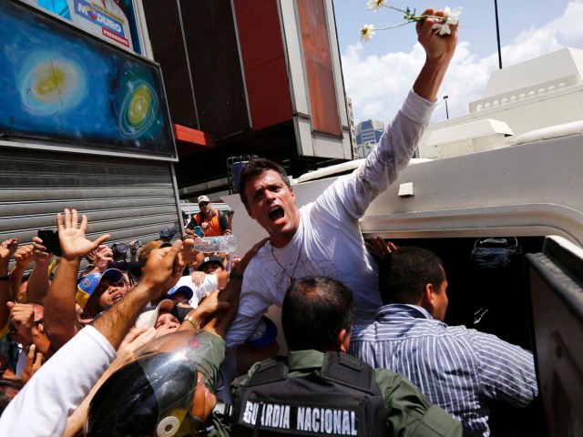 Venezuelan opposition leader Leopoldo Lopez gets into a National Guard armored vehicle in Caracas