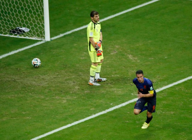 Robin van Persie of the Netherlands celebrates scoring past Spain's goalkeeper Iker Casillas during their 2014 World Cup Group B soccer match at the Fonte Nova arena in Salvador