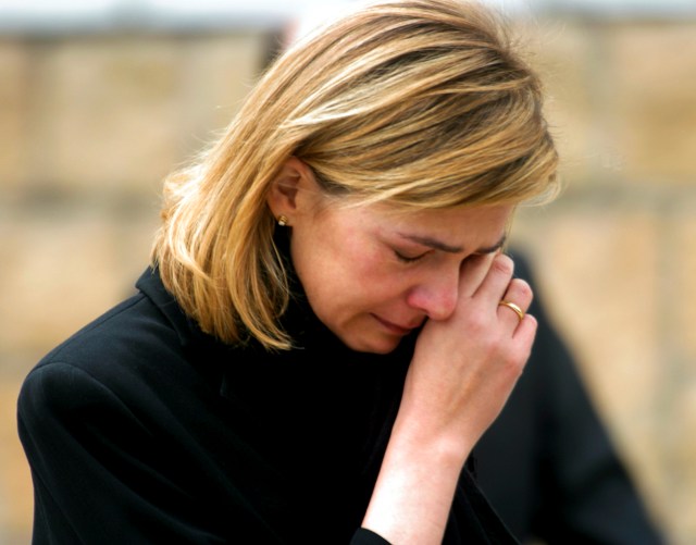 File photo of Spain's Infanta Cristina wiping her tears as she leaves Madrid's Almudena cathedral after attending the state funeral for the 190 victims of the Madrid train bombings