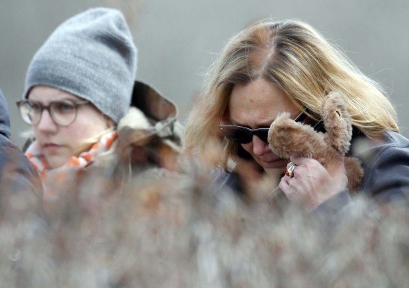 People identified by the mayor of Le Vernet as family members of the pilot of the Germanwings Airbus A320 react as they pay their respects at the memorial for the victims of the air disaster in the village of Le Vernet