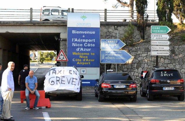 Taxi drivers, who are on strike, block the access of Nice International airport during a national protest against car-sharing service Uber in Nice