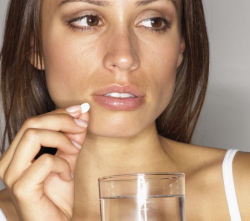 Woman taking an aspirin