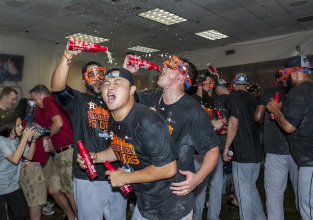 PHOENIX, AZ - OCTOBER 4: Hank Conger #16 of the Houston Astros celebrates with his team after clinching an American League wild card spot after a MLB game against the Arizona Diamondbacks on October 4, 2015 at Chase Field in Phoenix, Arizona.   Darin Wallentine/Getty Images/AFP