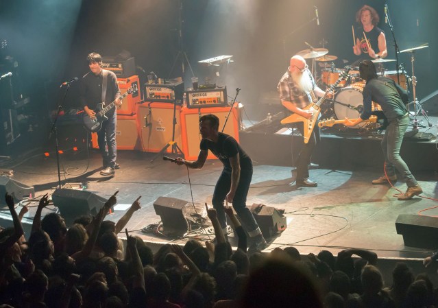 American rock group Eagles of Death Metal perform on stage on November 13, 2015 at the Bataclan concert hall in Paris, few moments before four men armed with assault rifles and shouting "Allahu akbar" ("God is great!") stormed into the venue. Islamic State jihadists on November 14, 2015 claimed a series of coordinated attacks by gunmen and suicide bombers in Paris that killed at least 128 people in scenes of carnage at the Bataclan, restaurants and the national stadium.   AFP PHOTO / ROCK&FOLK / MARION RUSZNIEWSKI