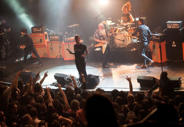 American rock group Eagles of Death Metal perform on stage on November 13, 2015 at the Bataclan concert hall in Paris, few moments before four men armed with assault rifles and shouting "Allahu akbar" ("God is great!") stormed into the venue. Islamic State jihadists on November 14, 2015 claimed a series of coordinated attacks by gunmen and suicide bombers in Paris that killed at least 128 people in scenes of carnage at the Bataclan, restaurants and the national stadium.   AFP PHOTO / ROCK&FOLK / MARION RUSZNIEWSKI