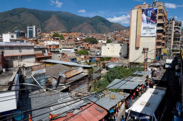 A building in the Petare neighborhood shows electoral propaganda of Venezuelan opposition deputy and candidate for the upcoming legislative elections Miguel Pizarro, in  Caracas on December 1 , 2015. Sixteen years into late president Hugo Chavez's leftist "revolution," opinion polls indicate the opposition is poised to win legislative elections Sunday for the first time since the firebrand leader came to power.  AFP PHOTO/FEDERICO PARRA / AFP / FEDERICO PARRA