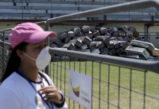 Una mujer mira una pila de ataúdes vacíos en el estadio Maximino Puertas, en Pedernales, Ecuador. 19 de abril de 2016. Tres días después del feroz terremoto que estremeció a Ecuador, miles aguardaban resignados los cuerpos de sus familiares para poder despedirse por última vez. Otros, optimistas, continuaban en vigilia a la espera de que rescatistas hallaran a los suyos. REUTERS/Henry Romero