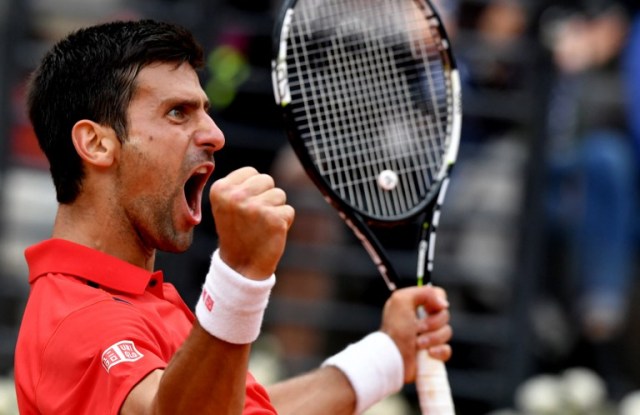 Serbia's Novak Djokovic reacts against Spanish Rafael Nadal during the ATP Tennis Open tournament at the Foro Italico, on May 13, 2016 in Rome. / AFP PHOTO / TIZIANA FABI