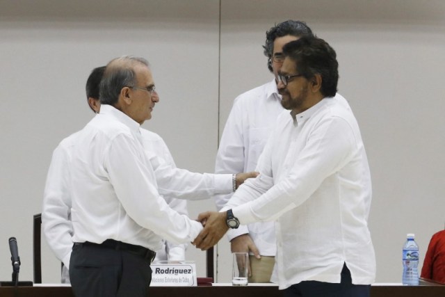 El principal negociador del Gobierno colombiano, Humberto de la Calle (izq.) le da la mano al negociador del equipo de las FARC, Iván Márquez, en La Habana, Cuba. 15 de diciembre de 2015. El Gobierno colombiano y la guerrilla de las FARC llegaron a un histórico acuerdo para declarar un cese al fuego bilateral definitivo que marcará el fin del conflicto armado más antiguo de América Latina, dijo el miércoles una fuente de la oficina del alto comisionado para la paz. REUTERS/Stringer