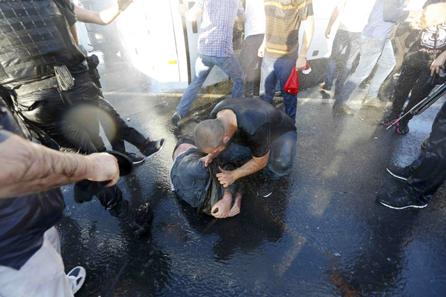 A civilian beats a soldier after troops involved in the coup surrendered on the Bosphorus Bridge in Istanbul, Turkey July 16, 2016. REUTERS/Murad Sezer TPX IMAGES OF THE DAY