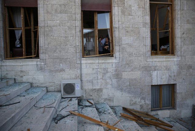 People look through broken windows of the parliament building in Ankara, Turkey, July 16, 2016. REUTERS/Baz Ratner