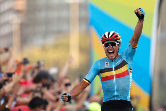 Belgium's Greg Van Avermaet celebrates after winning the Men's Road cycling race in the Rio 2016 Olympic Games in Rio de Janeiro on August 6, 2016. / AFP PHOTO / Adrian DENNIS