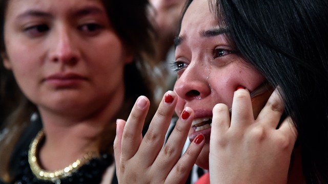 A woman cries as she speaks on her mobile phone after knowing the results of a referendum on whether to ratify a historic peace accord to end a 52-year war between the state and the communist FARC rebels, in Cali, Colombia, on October 2, 2016. Colombian voters rejected a peace deal with communist FARC rebels Sunday, near-complete referendum results indicated, blasting away what the government hoped would be a historic end to a 52-year conflict. / AFP PHOTO / GUILLERMO LEGARIA