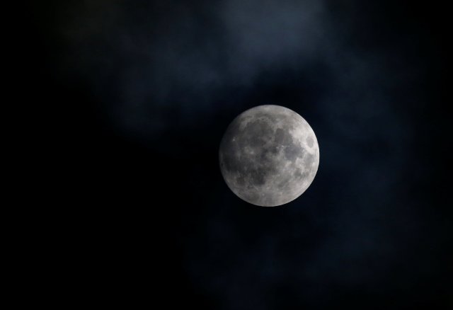 The moon appears in the sky a day before the "supermoon" spectacle in Vienna, Austria, November 13, 2016. REUTERS/Leonhard Foeger