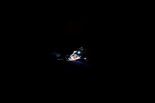 FILE PHOTO - A woman prepares to sleep on the floor next to her baby in a partially destroyed school used as a shelter after Hurricane Matthew hit Jeremie, Haiti, October 11, 2016. REUTERS/Carlos Garcia Rawlins/File Photo REUTERS PICTURES OF THE YEAR 2016 - SEARCH 'POY 2016' TO FIND ALL IMAGES