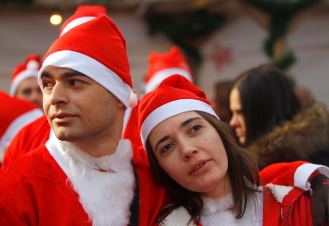 Runners dressed as Santa Claus take part in the annual Christmas race on the streets of Skopje, Macedonia December 25, 2016. REUTERS/Ognen Teofilovski