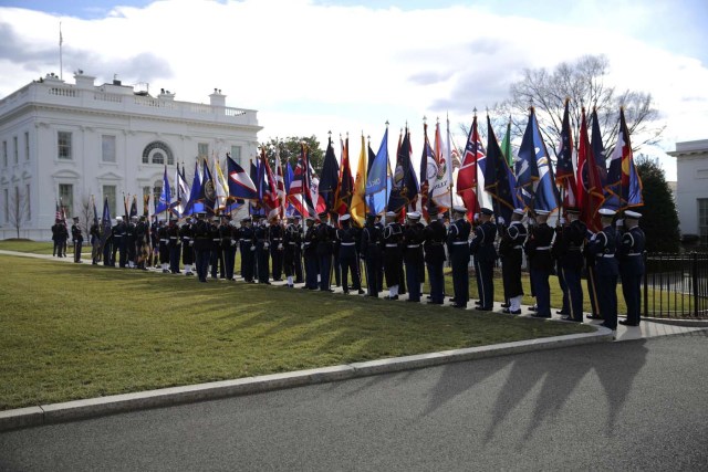 Members of a ceremonial guard carry flags prior to the arrival of British Prime Theresa May at the White House in Washington, U.S., January 27, 2017. REUTERS/Carlos Barria