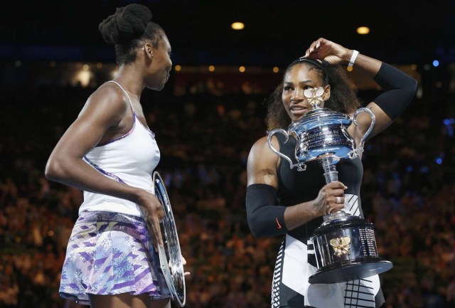 Tennis - Australian Open - Melbourne Park, Melbourne, Australia - 28/1/17 Serena Williams of the U.S. gestures as she holds her trophy after winning her Women's singles final match against Venus Williams of the U.S. .REUTERS/Issei Kato