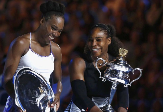 Tennis - Australian Open - Melbourne Park, Melbourne, Australia - 28/1/17 Serena Williams of the U.S. reacts as she holds her trophy after winning her Women's singles final match against Venus Williams of the U.S. .REUTERS/Thomas Peter