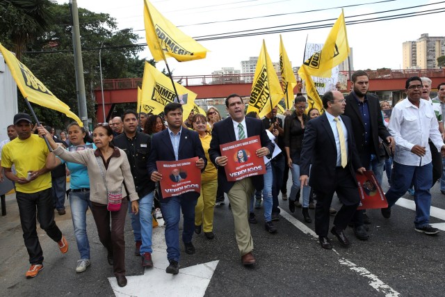 Juan Matheus (C), a deputy of the opposition party Justice First (Primero Justicia), holds a placard with an image of Venezuela's Supreme Court President Gladys Gutierrez, during a protest against Venezuelan President Nicolas Maduro's government outside the Supreme Court of Justice (TSJ) in Caracas, Venezuela February 9, 2017. REUTERS/Carlos Garcia Rawlins