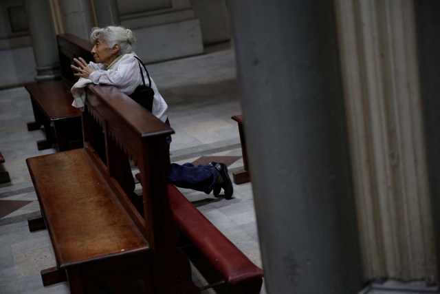 A woman prays at a church in downtown Caracas, Venezuela February 6, 2017. Picture taken February 6, 2017. REUTERS/Marco Bello