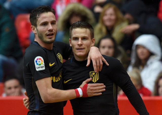 Football Soccer - Sporting Gijon v Atletico Madrid - Spanish La Liga Santander - El Molinon stadium, Gijon, Spain, 18/02/17 Atletico Madrid's Kevin Gameiro (R) is congratulated by team mate Saul Niguez after scoring a goal. REUTERS/Eloy Alonso