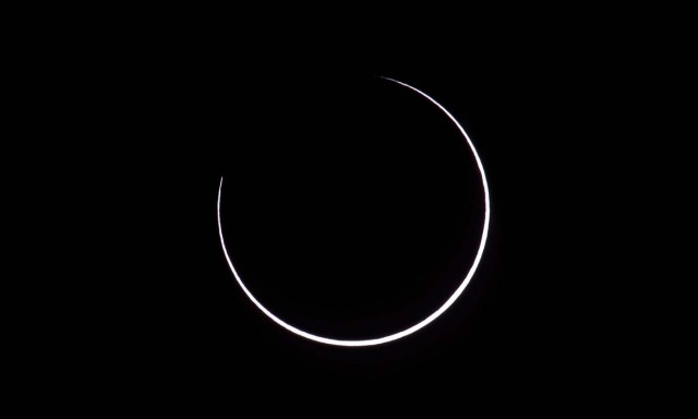 Picture taken on February 26, 2017 showing the moon moving to cover the sun for an annular solar eclipse, as seen from the Estancia El Muster, near Sarmiento, Chubut province, 1600 km south of Buenos Aires, Argentina, on February 26, 2017. Stargazers applauded as they were plunged into darkness Sunday when the moon passed in front of the sun in a spectacular "ring of fire" eclipse. / AFP PHOTO / ALEJANDRO PAGNI