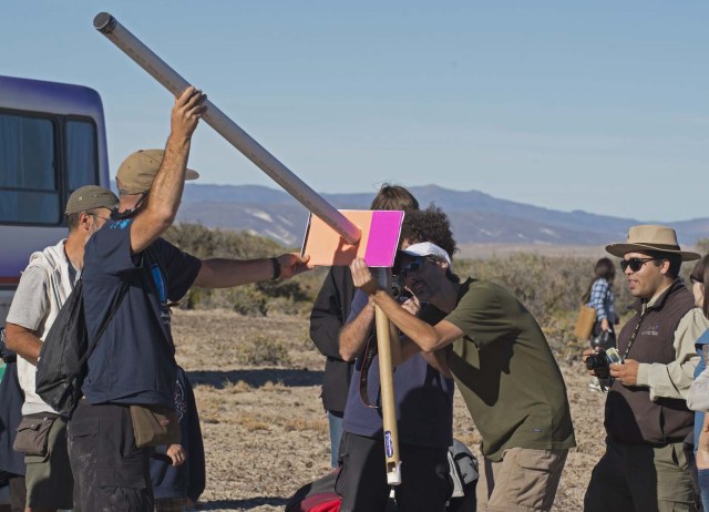 Picture taken on February 26, 2017 showing people preparing to see an annular solar eclipse, at the Estancia El Muster, near Sarmiento, Chubut province, 1600 km south of Buenos Aires, Argentina, on February 26, 2017. Stargazers applauded as they were plunged into darkness Sunday when the moon passed in front of the sun in a spectacular "ring of fire" eclipse. / AFP PHOTO / ALEJANDRO PAGNI