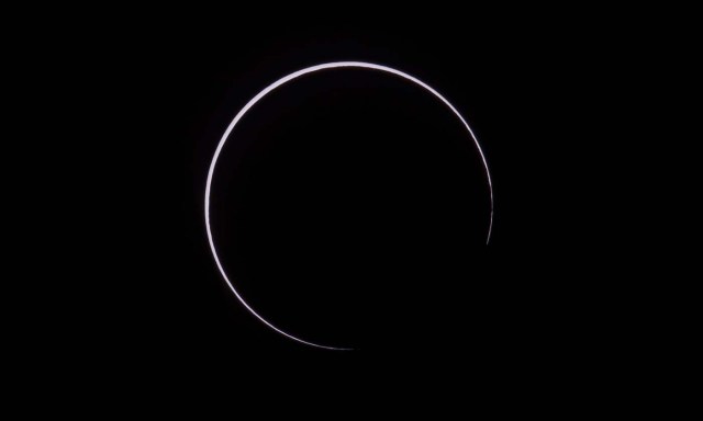 Picture taken on February 26, 2017 showing the moon moving to cover the sun for an annular solar eclipse, as seen from the Estancia El Muster, near Sarmiento, Chubut province, 1600 km south of Buenos Aires, Argentina, on February 26, 2017. Stargazers applauded as they were plunged into darkness Sunday when the moon passed in front of the sun in a spectacular "ring of fire" eclipse. / AFP PHOTO / ALEJANDRO PAGNI