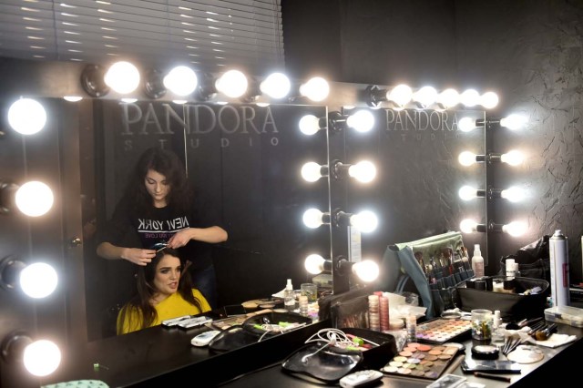 TO GO WITH AFP STORY BY OLGA SHYLENKO A makeup artist works on the hair of Ukrainian model Alexandra Kutas, who is in a wheelchair from a very early age due to a spinal cord injury resulting from a doctor's mistake at birth, prior to a photo and video fashion shoot in Kiev on January 25, 2017. Kutas, 23, is Ukraine's first model with a disability to headline a runway event of this level, after covering a long and thorny path for her dream to come true. / AFP PHOTO / Sergei SUPINSKY / ?The erroneous mention[s] appearing in the metadata of this photo by Sergei SUPINSKY has been modified in AFP systems in the following manner: [a spinal cord injury resulting from a doctor's mistake at birth] instead of [cerebral palsy]. Please immediately remove the erroneous mention[s] from all your online services and delete it (them) from your servers. If you have been authorized by AFP to distribute it (them) to third parties, please ensure that the same actions are carried out by them. Failure to promptly comply with these instructions will entail liability on your part for any continued or post notification usage. Therefore we thank you very much for all your attention and prompt action. We are sorry for the inconvenience this notification may cause and remain at your disposal for any further information you may require.?