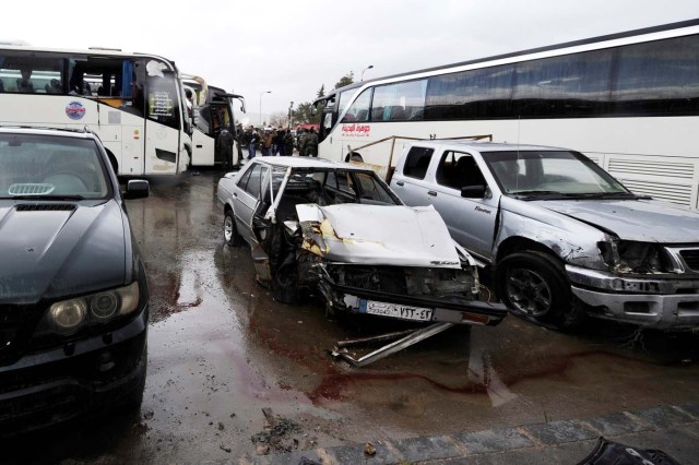 Damaged vehicles are pictured at the site of an attack by two suicide bombers in Damascus, Syria  March 11, 2017.  REUTERS/Omar Sanadiki