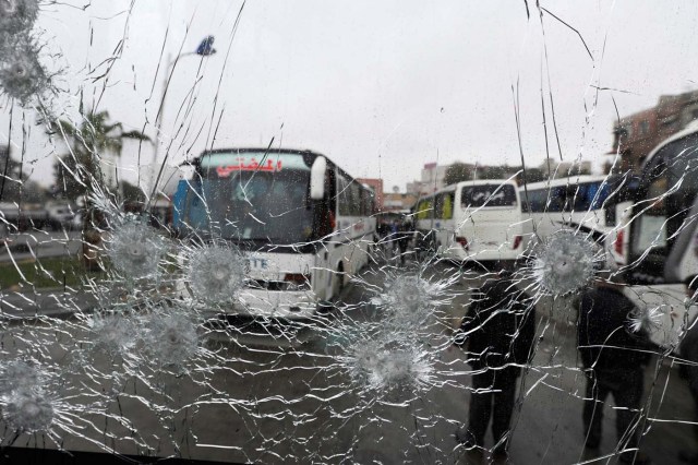 People are seen though a shattered glass window of a bus at the site of an attack by two suicide bombers in Damascus, Syria  March 11, 2017.  REUTERS/Omar Sanadiki     TPX IMAGES OF THE DAY