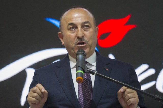 Turkish Foreign Minister Mevlut Cavusoglu delivers a speech during his visit to his country's hall at the Internationale Tourismus-Boerse (ITB) international travel trade show in Berlin on March 8, 2017. Cavusoglu said he expected to host his German counterpart Sigmar Gabriel "as soon as possible," as the NATO allies struggle to end a bad-tempered row. / AFP PHOTO / STEFFI LOOS