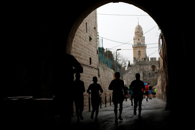 Athletes run inside Jerusalem's Old City during the seventh International Jerusalem Marathon March 17, 2017. REUTERS/Ronen Zvulun