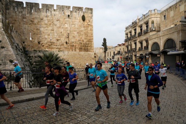 Athletes run inside Jerusalem's Old City during the seventh International Jerusalem Marathon March 17, 2017. REUTERS/Ronen Zvulun