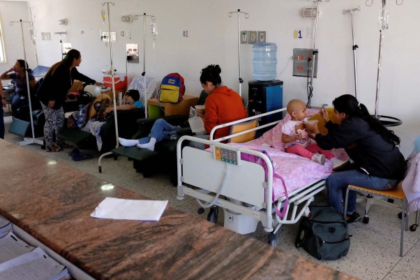 A mother feeds her child with soup prepared by Chef Elisa Bermudez (not pictured) and volunteers of the "Full Stomach, Happy Heart" (Barriga llena, corazon contento) charity, at the J.M. de los Rios Children Hospital in Caracas, Venezuela February 22, 2017. Picture taken February 22, 2017. REUTERS/Marco Bello