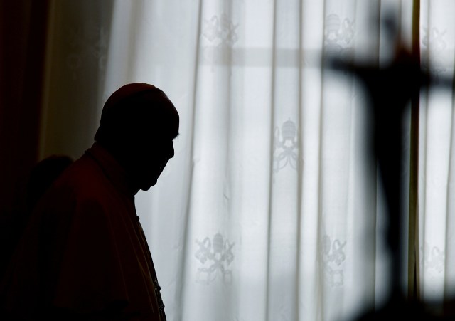 Pope Francis is silhouetted at the end of a private audience with Cameroon's President Paul Biya at the Vatican March 23, 2017. REUTERS/Vincenzo Pinto/pool