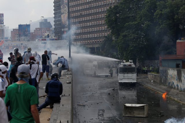 Police use a water cannon to disperse demonstrators during an opposition rally in Caracas, Venezuela April 6, 2017. REUTERS/Carlos Garcia Rawlins