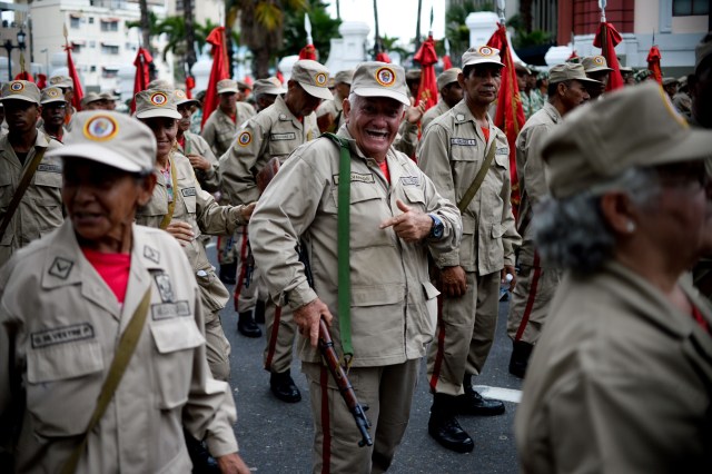 Members of the Bolivarian Militia take part in a parade in the framework of the seventh anniversary of the force, in front of the Miraflores presidential palace in Caracas on April 17, 2017. Venezuela's defence minister on Monday declared the army's loyalty to Maduro, who ordered troops into the streets ahead of a major protest by opponents trying to oust him. Venezuela is bracing for what Maduro's opponents vow will be the "mother of all protests" Wednesday, after two weeks of violent demos against moves by the leftist leader and his allies to tighten their grip on power. / AFP PHOTO / Federico PARRA