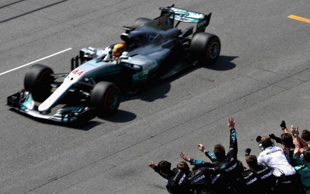 MONTREAL, QC - JUNE 11: Race winner Lewis Hamilton of Great Britain and Mercedes GP drives past his team as the celebrate on the pit wall during the Canadian Formula One Grand Prix at Circuit Gilles Villeneuve on June 11, 2017 in Montreal, Canada.   Mark Thompson/Getty Images/AFP