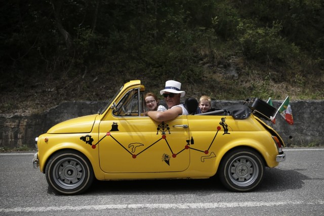 An enthusiast looks on during the 34th International Rally of Fiat 500 Club Italia for the 60th anniversary of this car on July 8, 2017, in Garlenda, near Genoa.   More than 1200 cars came from Europe to take part at the 34 rally of Garlenda to celebrate the 60th anniversary of the Fiat 500.  / AFP PHOTO / Marco BERTORELLO