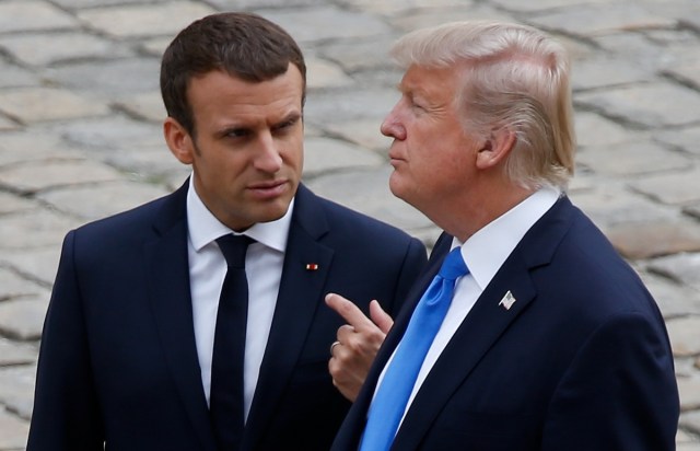 French President Emmanuel Macron and U.S. President Donald Trump walk in the courtyard as they leave after a welcoming ceremony at the Invalides in Paris, France, July 13, 2017. REUTERS/Charles Platiau