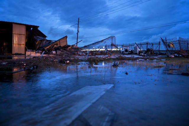 Damage is seen in the aftermath of Hurricane Harvey August 26, 2017 in Katy, Texas. Hurricane Harvey stalled over central Texas on Saturday, August 26, 2017, raising fears of "catastrophic" flooding after the megastorm -- the most powerful to hit the United States since 2005 -- left a deadly trail of devastation along the Gulf Coast. The latest forecasts show that Harvey, now downgraded to tropical storm status, will hover along the shore for the next four or five days, dumping massive amounts of rain. / AFP PHOTO / Brendan Smialowski