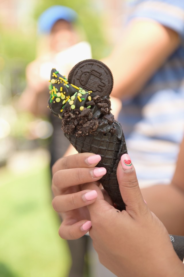 NEW YORK, NY - AUGUST 21: A guest samples a custom Little Damage ice cream flavor as Google and Oreo reveal Android OREO during the solar eclipse at the 14th street park on August 21, 2017 in New York City.   Jason Kempin/Getty Images for Oreo/AFP