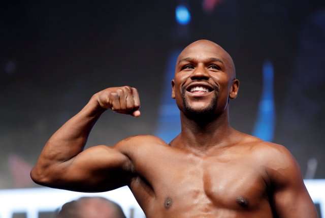 Undefeated boxer Floyd Mayweather Jr. of the U.S. poses on the scale during his official weigh-in at T-Mobile Arena in Las Vegas, Nevada, U.S. on August 25, 2017. REUTERS/Steve Marcus