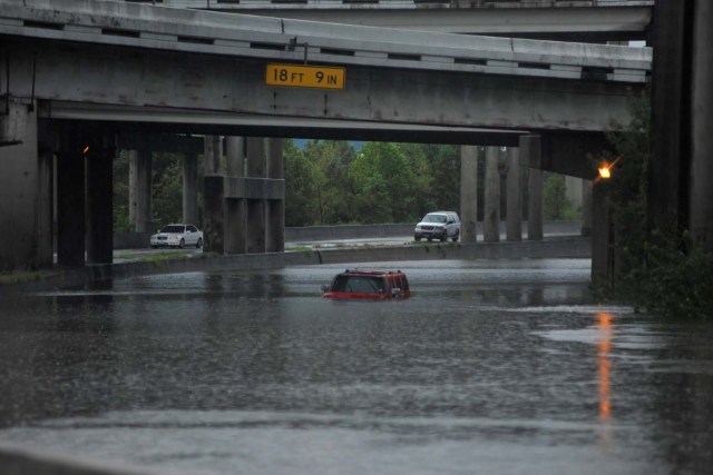 An abandoned Hummer is covered in floodwaters on Interstate 610 after Hurricane Harvey inundated the Texas Gulf coast with rain, in Houston, Texas, U.S. August 27, 2017. REUTERS/Nick Oxford