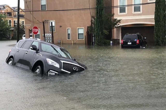 A vehicle sits half submerged in flood waters in a residential area in the aftermath of Hurricane Harvey in Houston, Texas, U.S., August 27, 2017. REUTERS/Ernest Scheyder