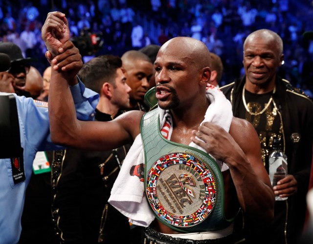 Boxing - Floyd Mayweather Jr. vs Conor McGregor - Las Vegas, USA - August 26, 2017  Floyd Mayweather Jr. celebrates with the belt after winning the fight REUTERS/Steve Marcus