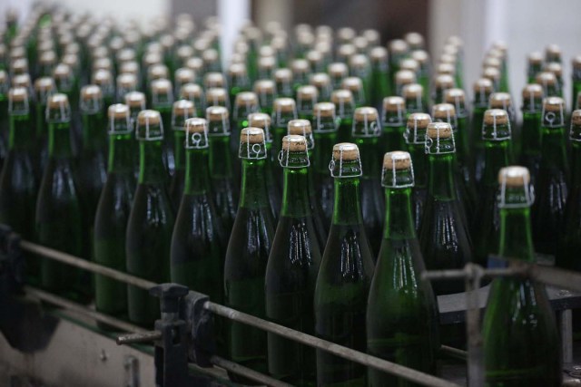 A picture taken on July 12, 2017 shows bottles of wine in the "Artwinery" winery firm in the eastern Ukrainian city of Bakhmut. The winery is located in a government-held town just two dozen kilometres (15 miles) from the frontline in Ukraine's low-level war, where the army and Russian-backed rebels continue to lob deadly artillery barrages at each other. The town spent around a month under rebel control in 2014, and in 2015 the frontline was so close that the town came under rebel shelling. But despite more than three years of fighting that has claimed some 10,000 lives, Nasyrov's employer, Artwinery, has never stopped production. / AFP PHOTO / Aleksey FILIPPOV