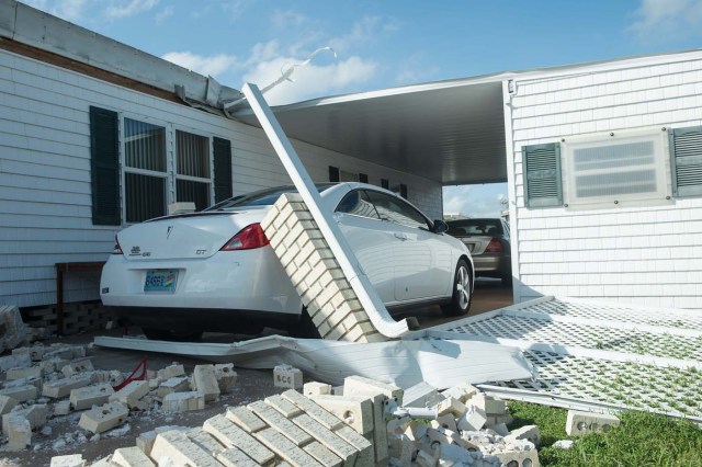 A damaged house is seen at the Enchanted Shores manufactured home park in Naples, Florida, on September 11, 2017 after Hurricane Irma hit Florida. / AFP PHOTO / NICHOLAS KAMM